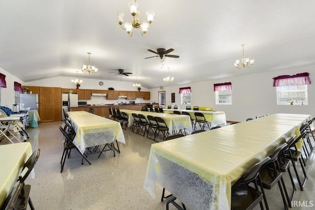 dining space with lofted ceiling and ceiling fan with notable chandelier