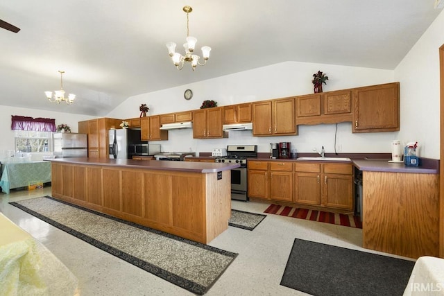 kitchen with sink, appliances with stainless steel finishes, pendant lighting, and a notable chandelier