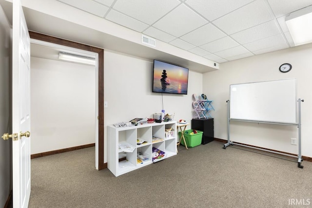 playroom with a drop ceiling and carpet floors