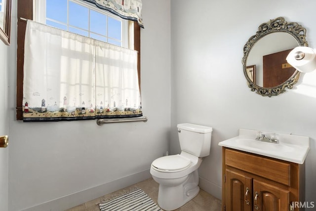 bathroom with tile patterned floors, vanity, and toilet