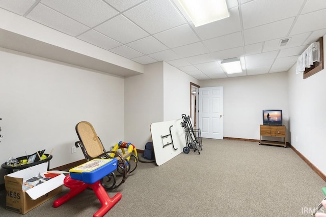 recreation room with a paneled ceiling and carpet floors