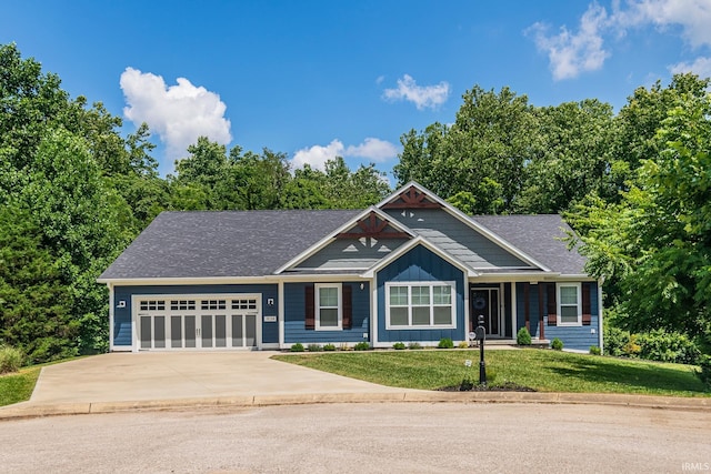 view of front of home with a garage and a front lawn