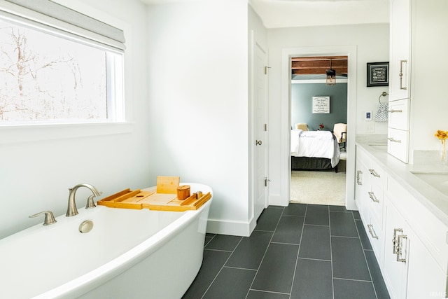 bathroom featuring tile patterned flooring, vanity, and a bathing tub