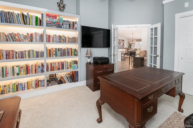 carpeted office featuring french doors