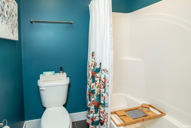 bathroom featuring a shower with curtain and toilet