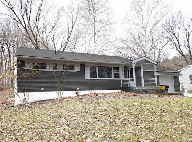 single story home featuring a garage and a front lawn