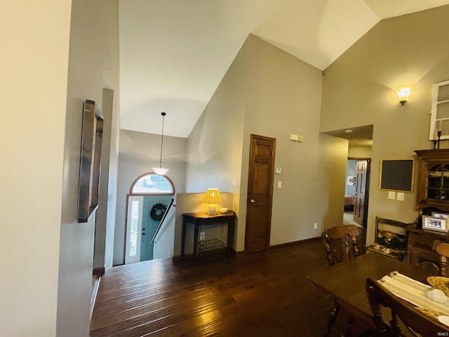 interior space with dark hardwood / wood-style flooring and high vaulted ceiling