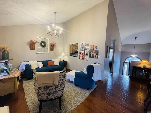 living room featuring hardwood / wood-style floors, high vaulted ceiling, and a notable chandelier