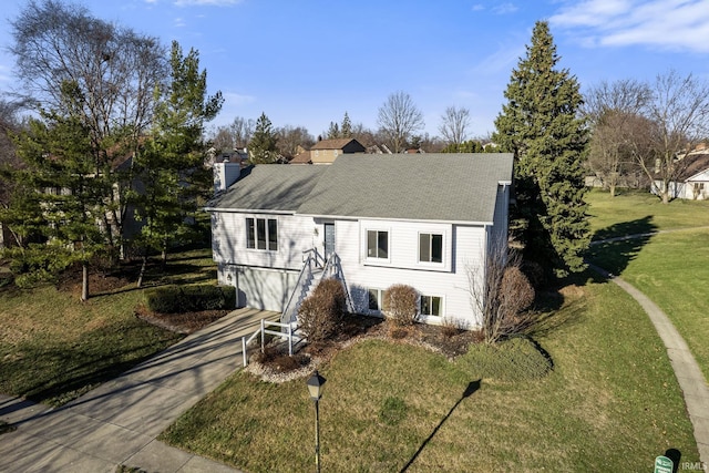 view of front of home featuring a garage and a front lawn