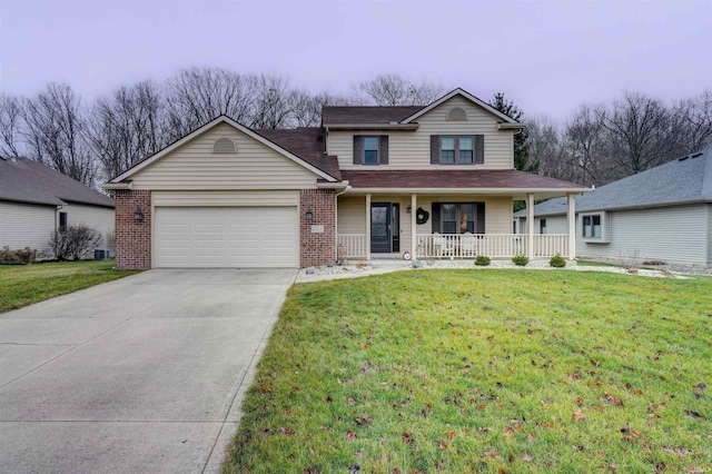 view of front of home featuring covered porch, a front yard, and a garage