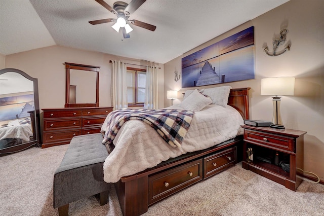 carpeted bedroom with ceiling fan, lofted ceiling, and a textured ceiling