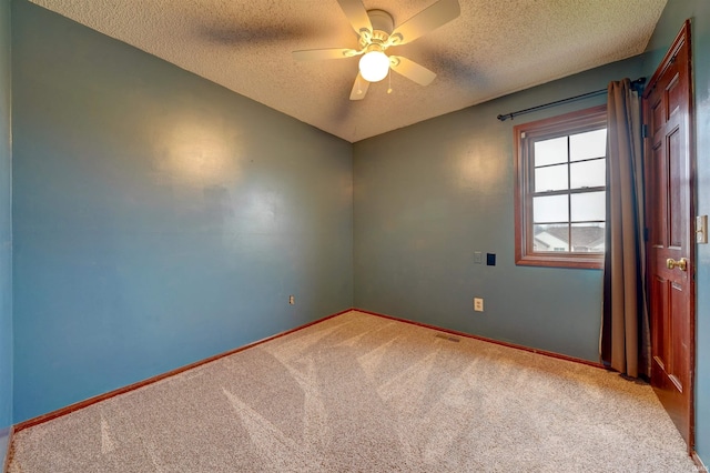 unfurnished room featuring a textured ceiling, carpet floors, and ceiling fan