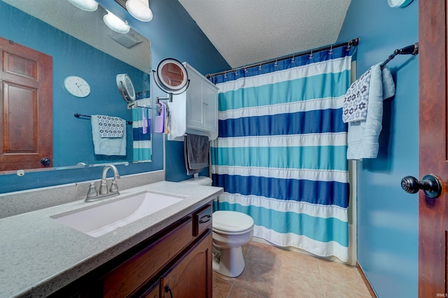 bathroom featuring vanity, a textured ceiling, tile patterned flooring, toilet, and curtained shower