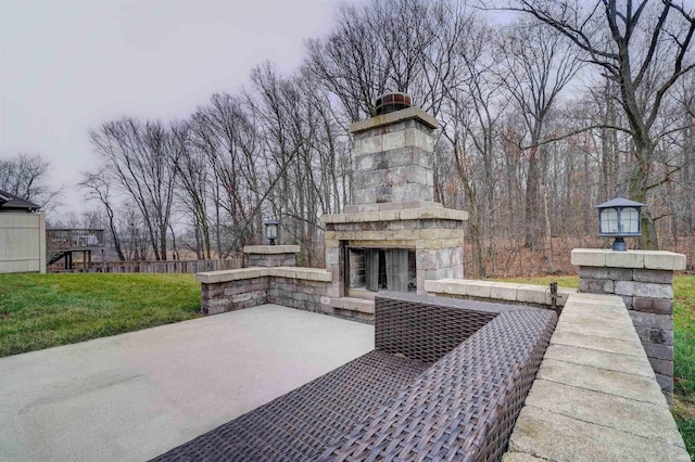 view of patio with an outdoor stone fireplace