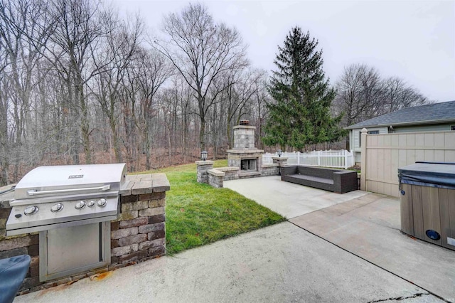 view of patio with an outdoor stone fireplace, a grill, and a hot tub