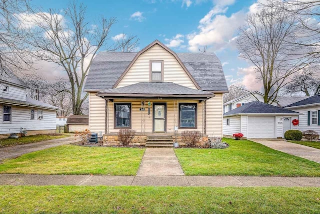 bungalow-style house with a porch, a garage, and a front lawn