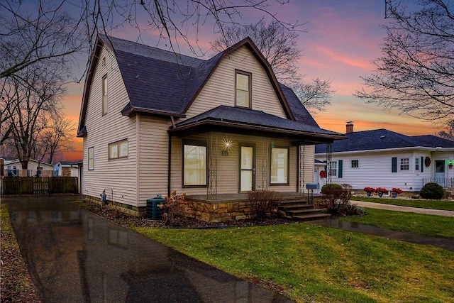 view of front of house with a yard and covered porch