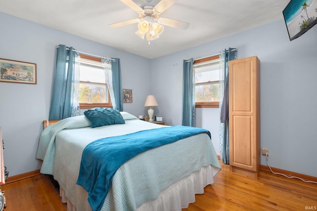 bedroom with ceiling fan and light hardwood / wood-style floors