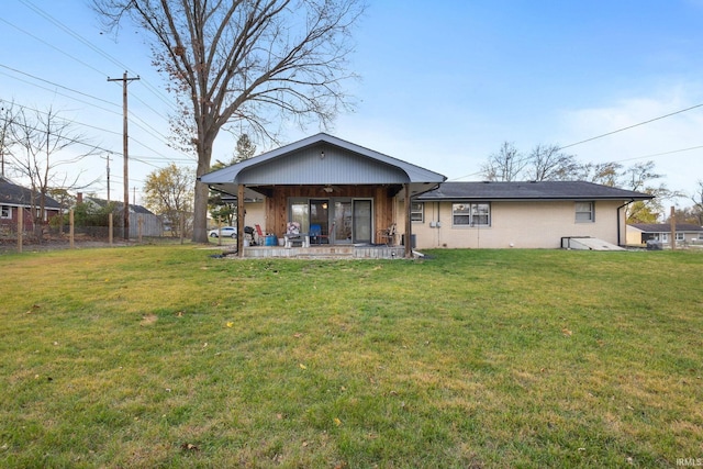 rear view of property featuring a yard