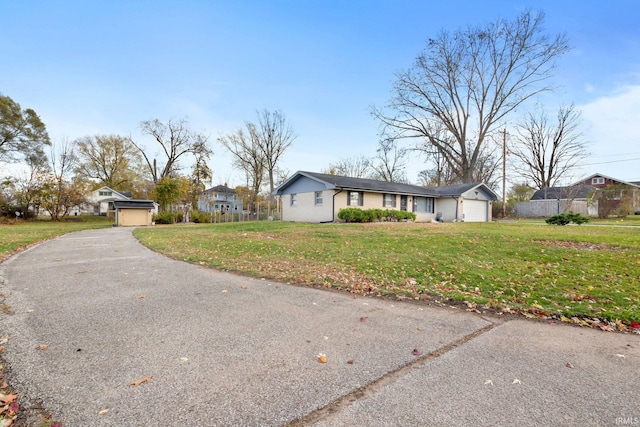 ranch-style home featuring a garage and a front lawn