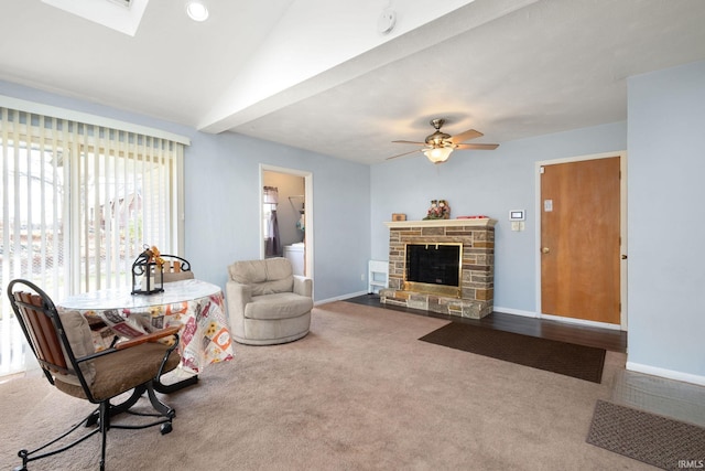 living room featuring carpet flooring, ceiling fan, lofted ceiling, and a fireplace