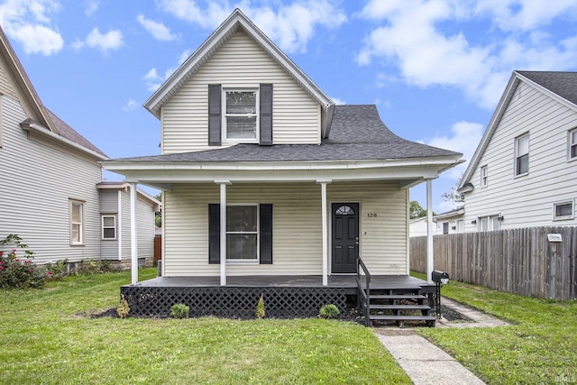 bungalow-style home with covered porch and a front lawn