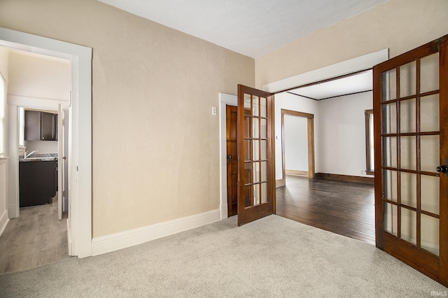 carpeted spare room with french doors