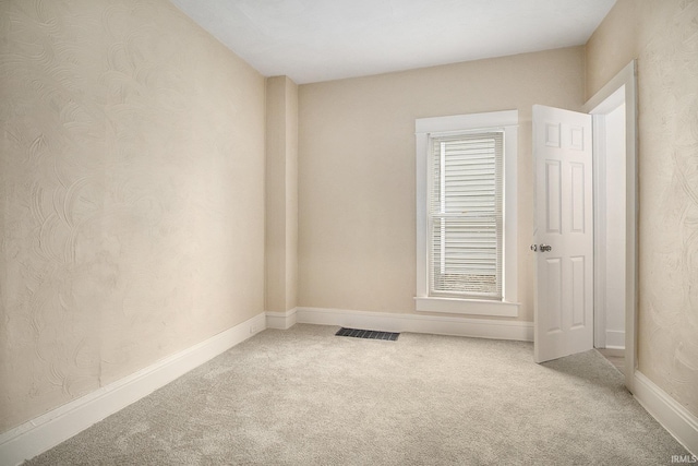 spare room featuring carpet