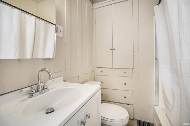 bathroom with vanity, toilet, and walk in shower