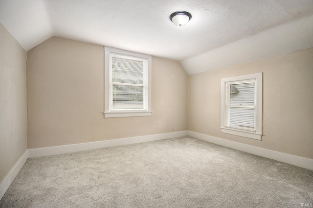 bonus room featuring carpet flooring and lofted ceiling