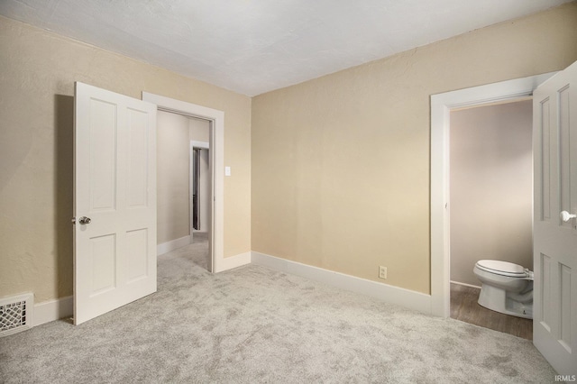 unfurnished bedroom featuring light carpet