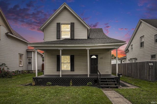 bungalow-style house with a porch and a yard