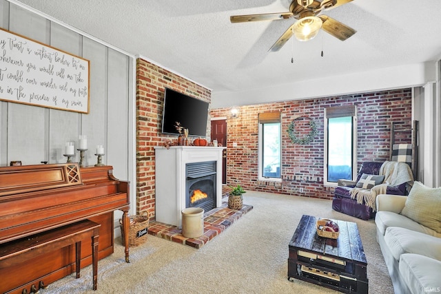 carpeted living room featuring ceiling fan and a textured ceiling