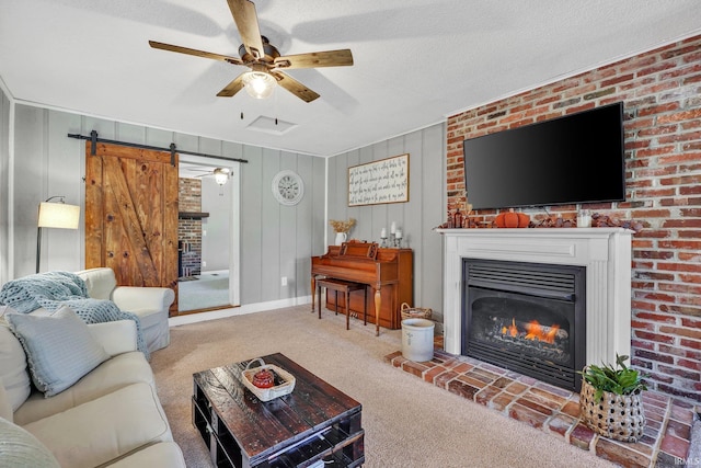 carpeted living room with a textured ceiling, a large fireplace, and wood walls