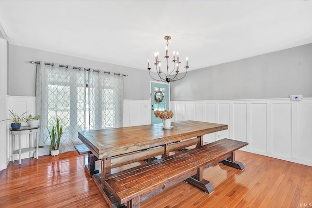 dining space featuring a notable chandelier and light hardwood / wood-style flooring