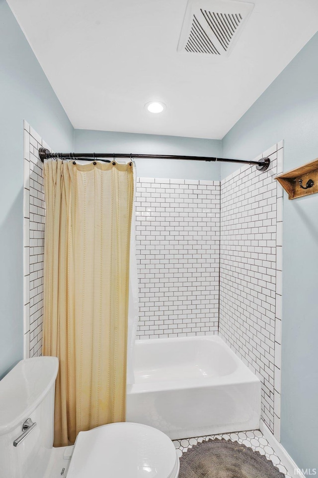 bathroom featuring shower / bath combination with curtain and toilet