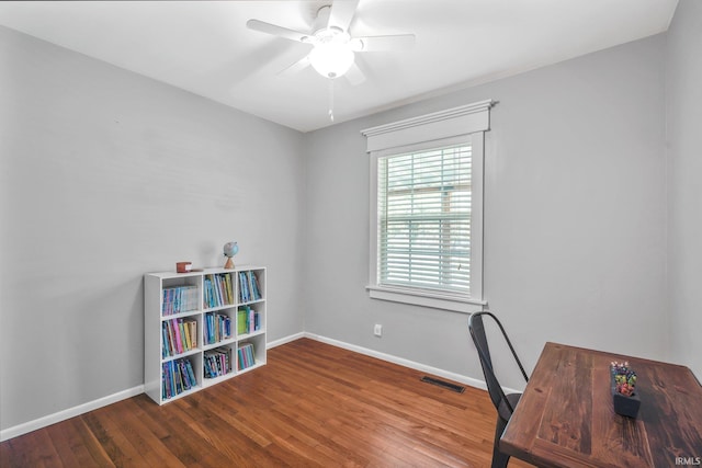 office with dark hardwood / wood-style floors and ceiling fan