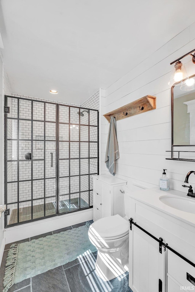 bathroom featuring wood walls, vanity, and toilet