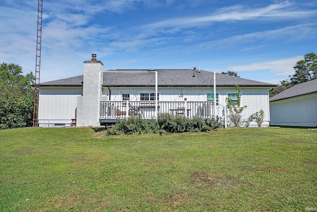 back of property featuring a deck and a yard