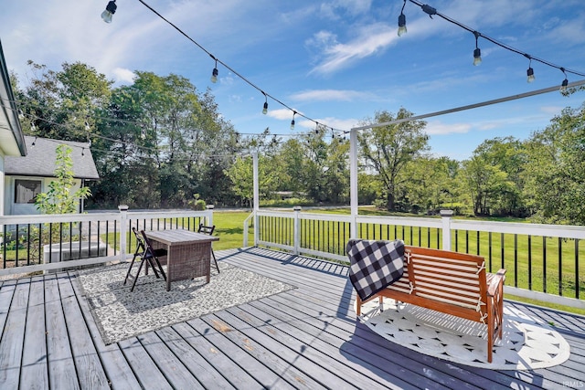 wooden terrace featuring a lawn