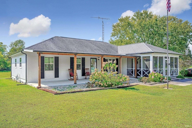 back of house with a lawn, a sunroom, and a patio area