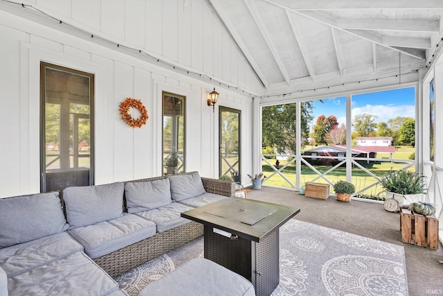 sunroom featuring vaulted ceiling with beams