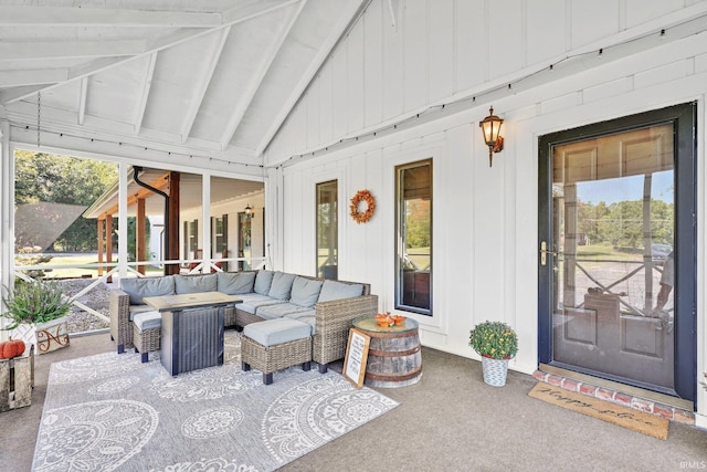 sunroom / solarium with vaulted ceiling with beams