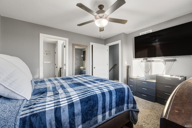 bedroom with carpet floors, ensuite bath, and ceiling fan