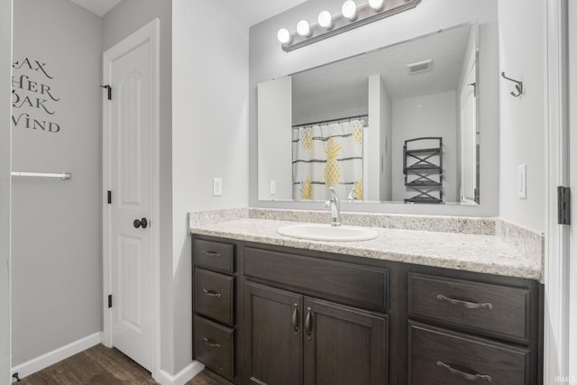 bathroom with hardwood / wood-style flooring and vanity