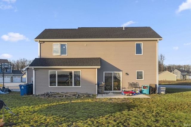 rear view of house featuring a lawn and a patio