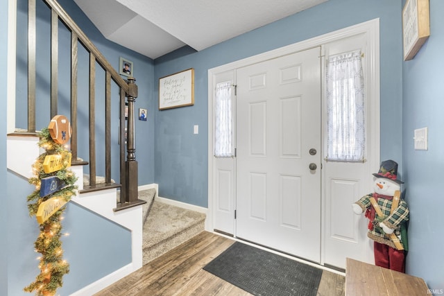 entryway with hardwood / wood-style flooring