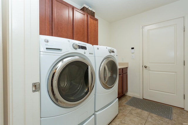 washroom featuring cabinets and independent washer and dryer