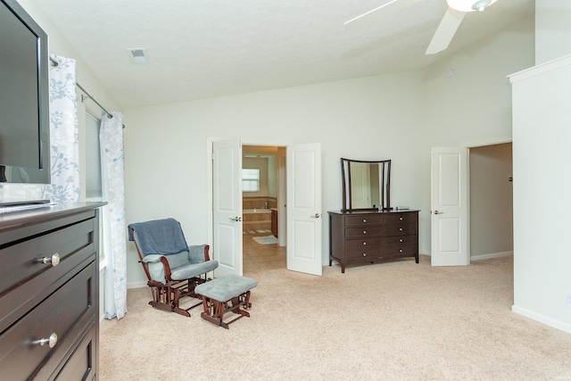 living area featuring ceiling fan, high vaulted ceiling, and light colored carpet