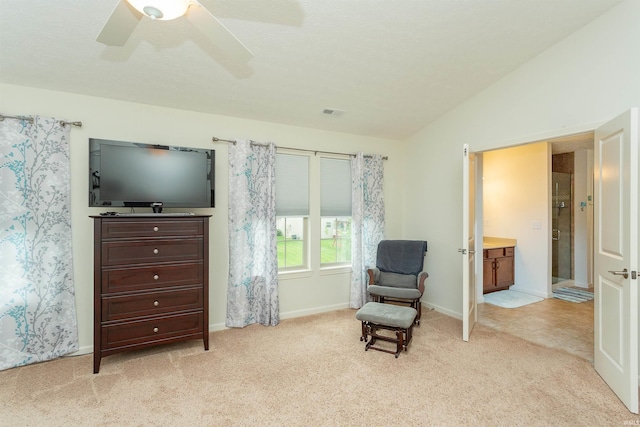 living area with ceiling fan, lofted ceiling, and light carpet